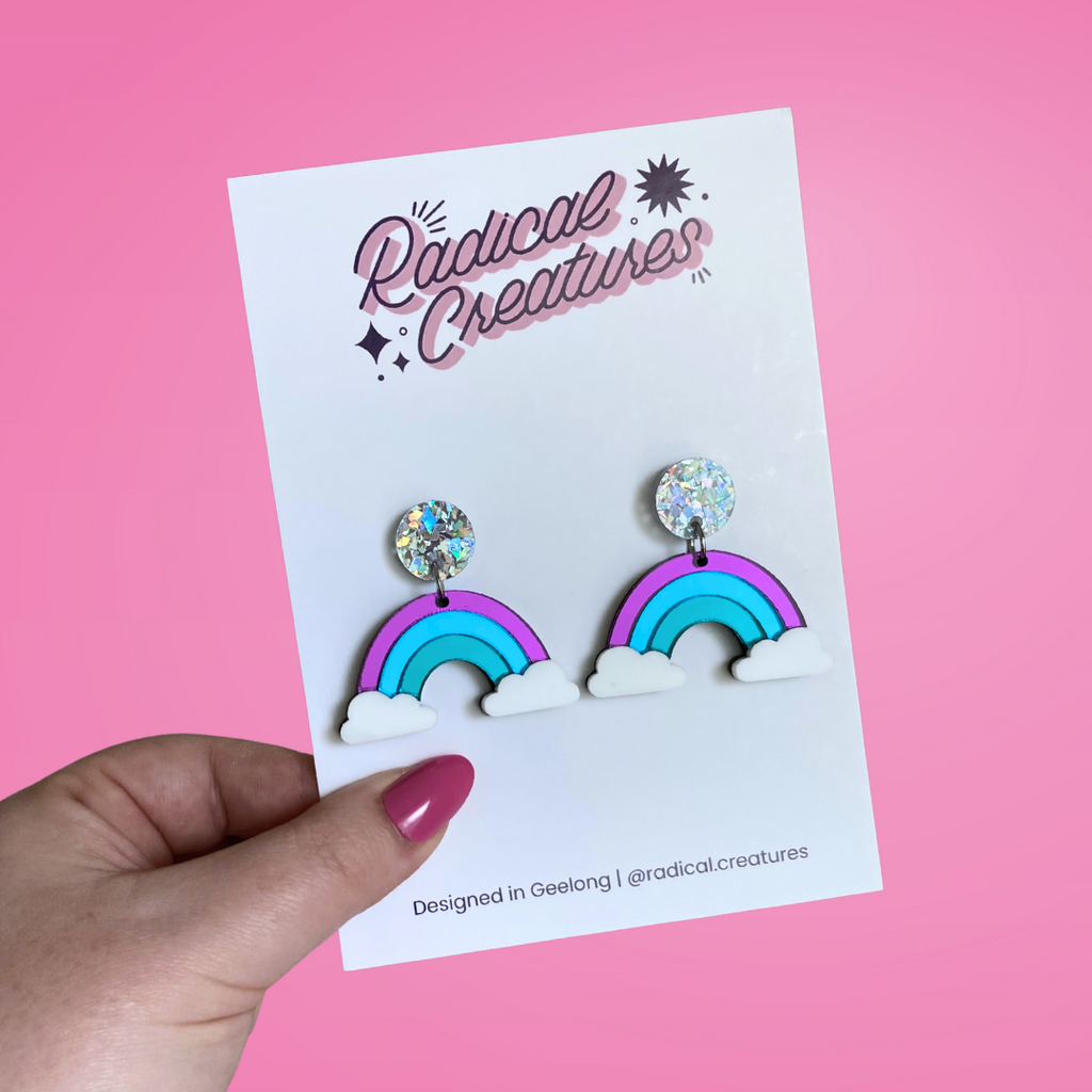 Mirror rainbow dangle earrings with sparkly circle earring topper. Rainbow colours are mirror purple/blue/mint with white clouds.