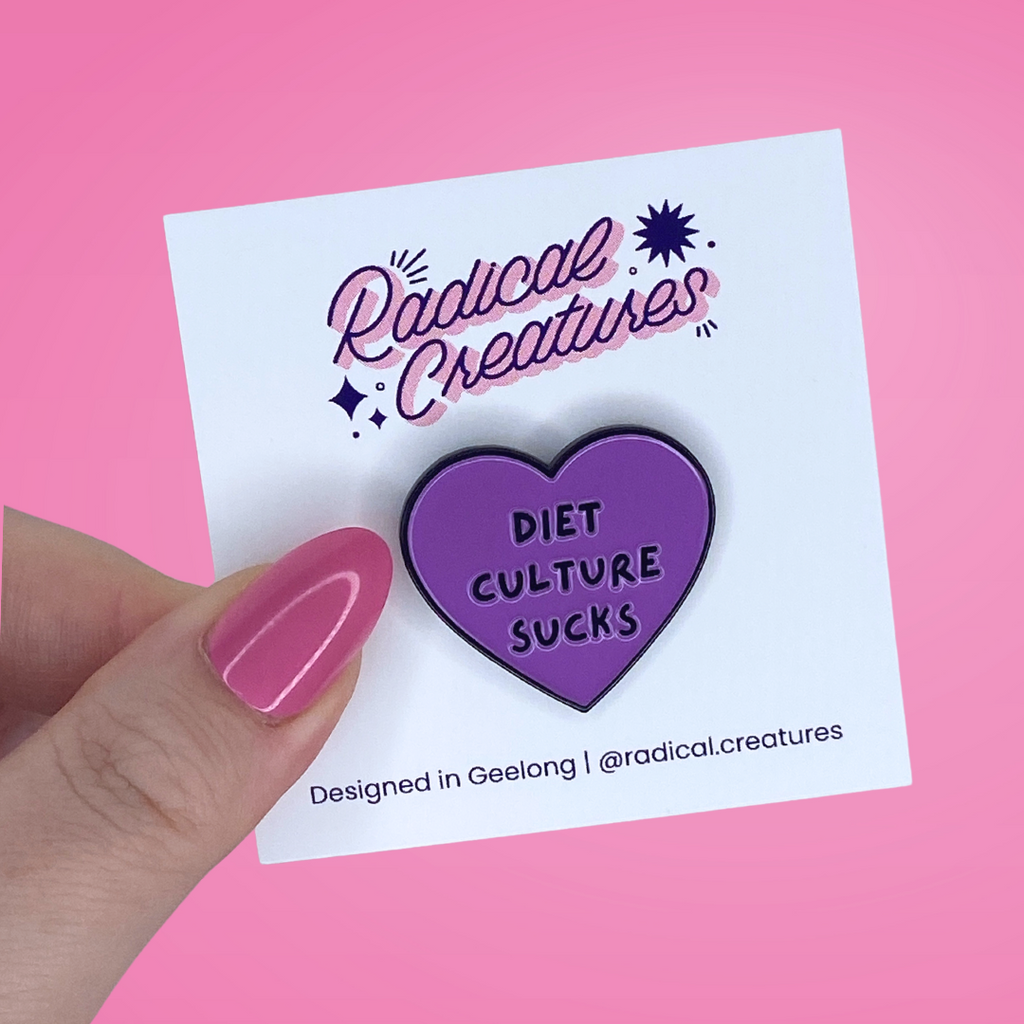 Heart shaped pin. Purple with text "diet culture sucks"