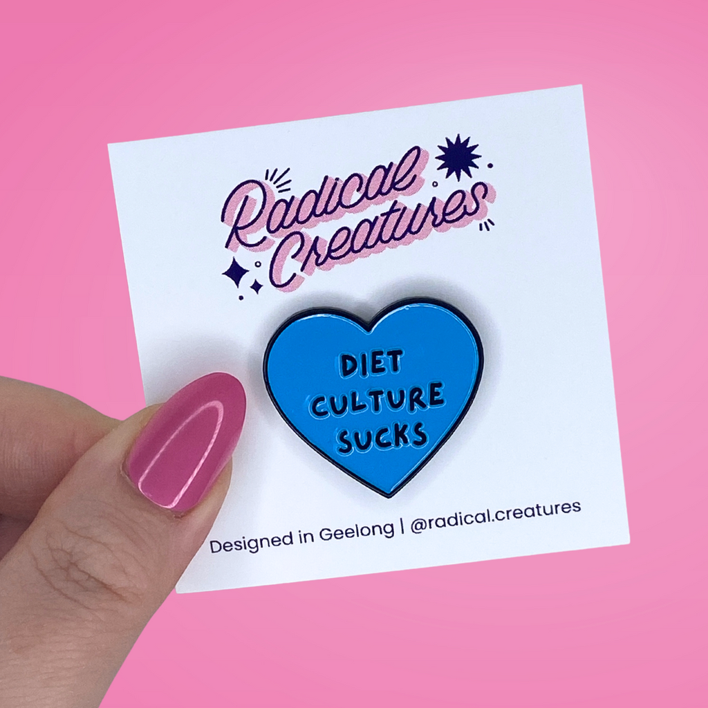 Heart shaped pin. Blue with text "diet culture sucks"